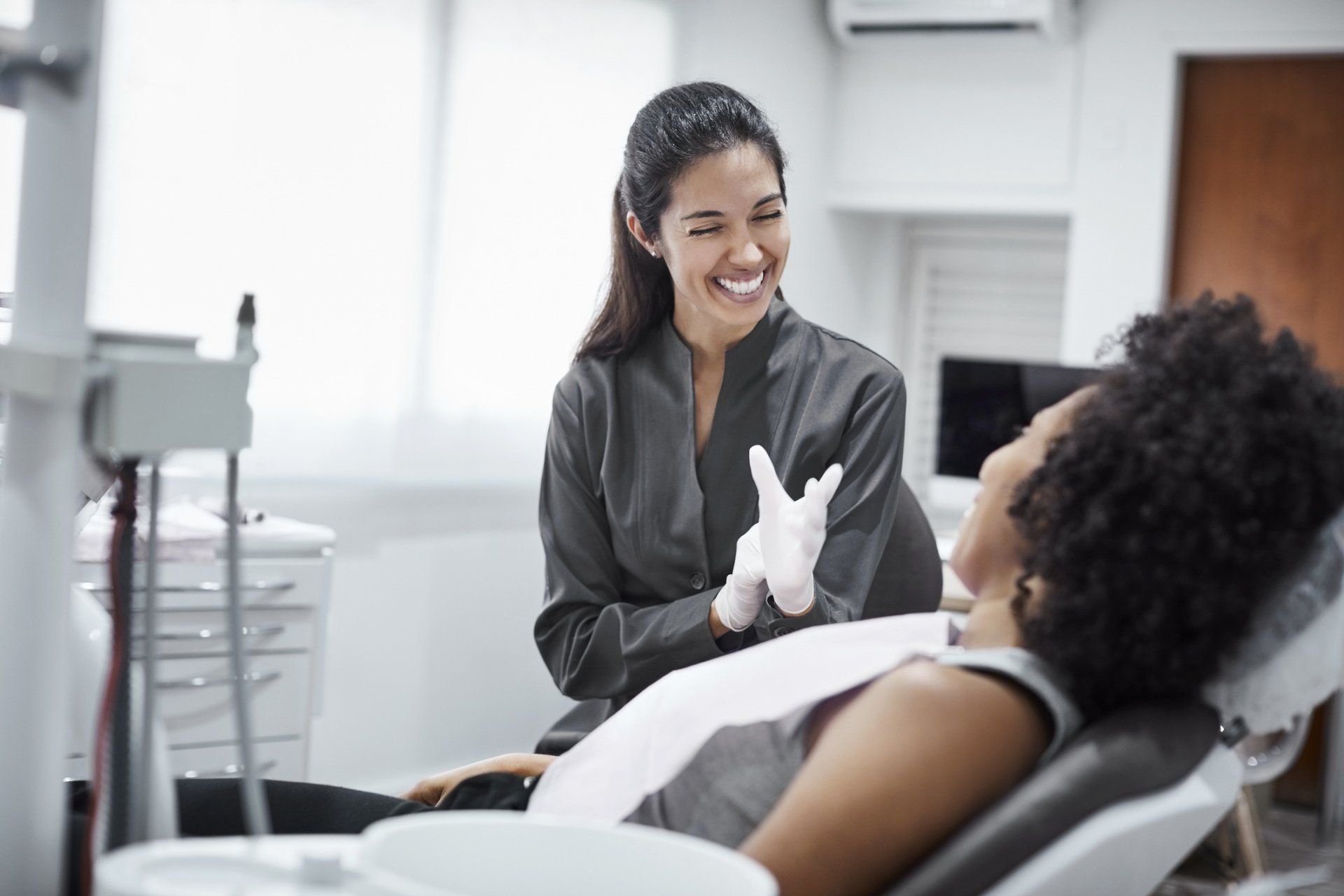 woman being counseled by dentist at Sewell Dental  Designs
