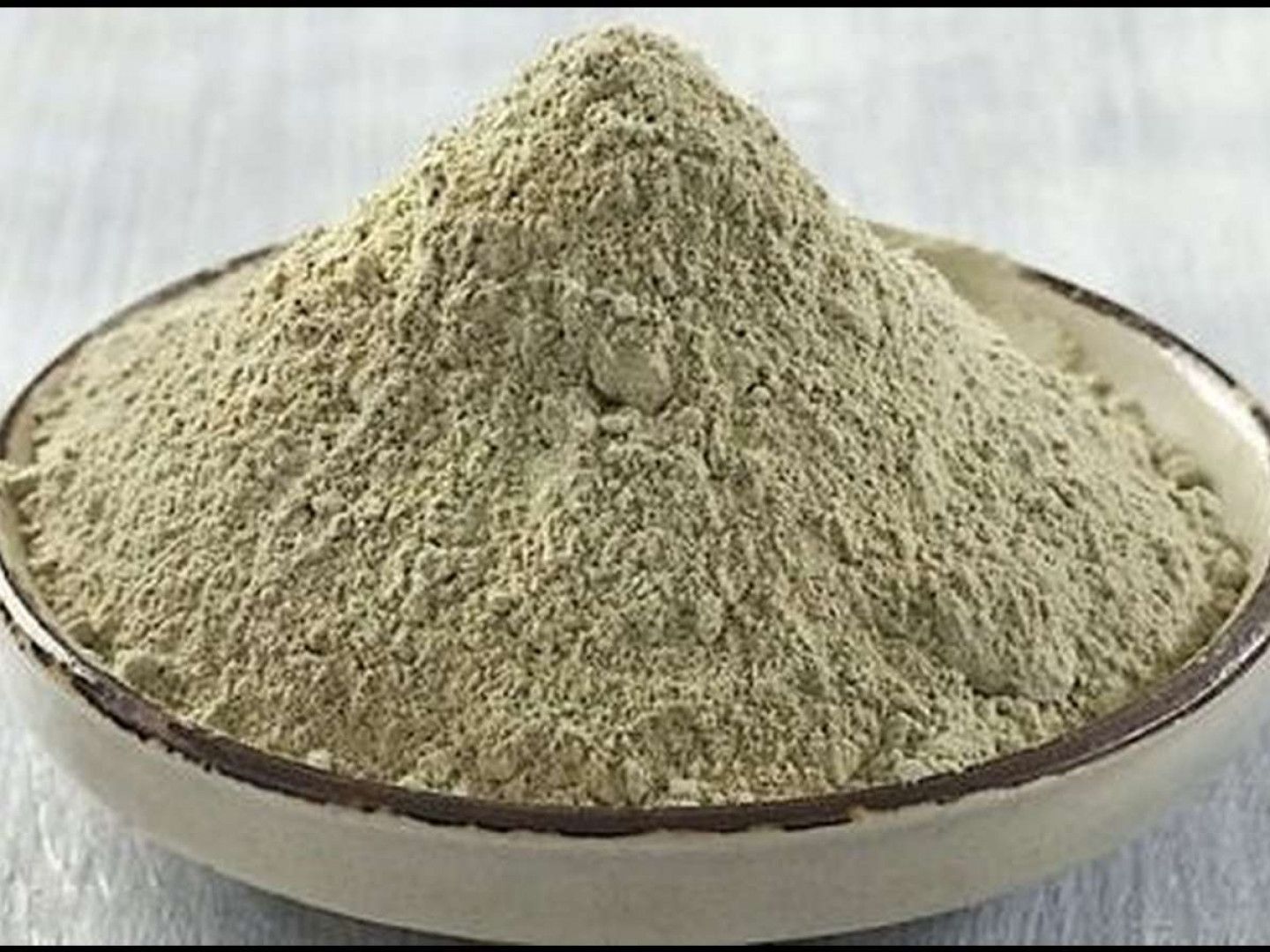 A pile of light-green powder in a shallow, off-white bowl.