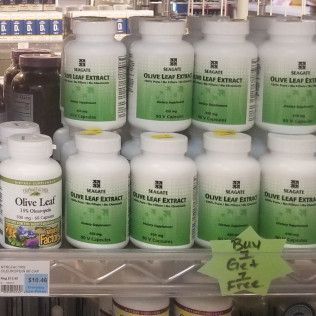 Bottles of olive leaf extract on a shelf in a store, with a 