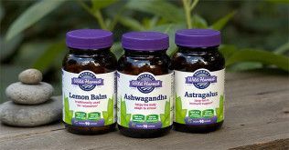 Three brown supplement bottles with purple lids labeled