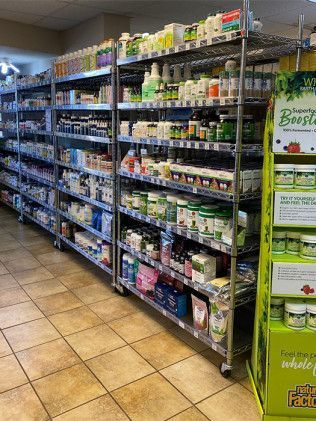 Shelves stocked with various vitamins and supplements in a store setting.