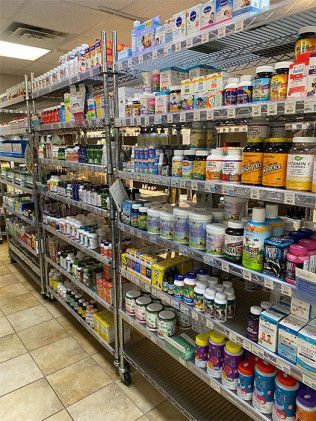 Shelves stocked with vitamins and supplements in a store setting.