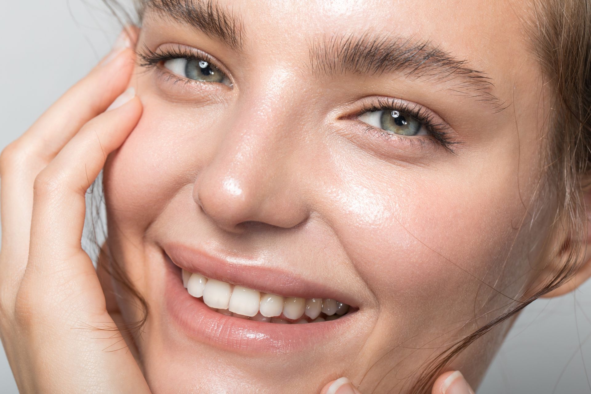 A close up of a woman 's face with a smile on her face.