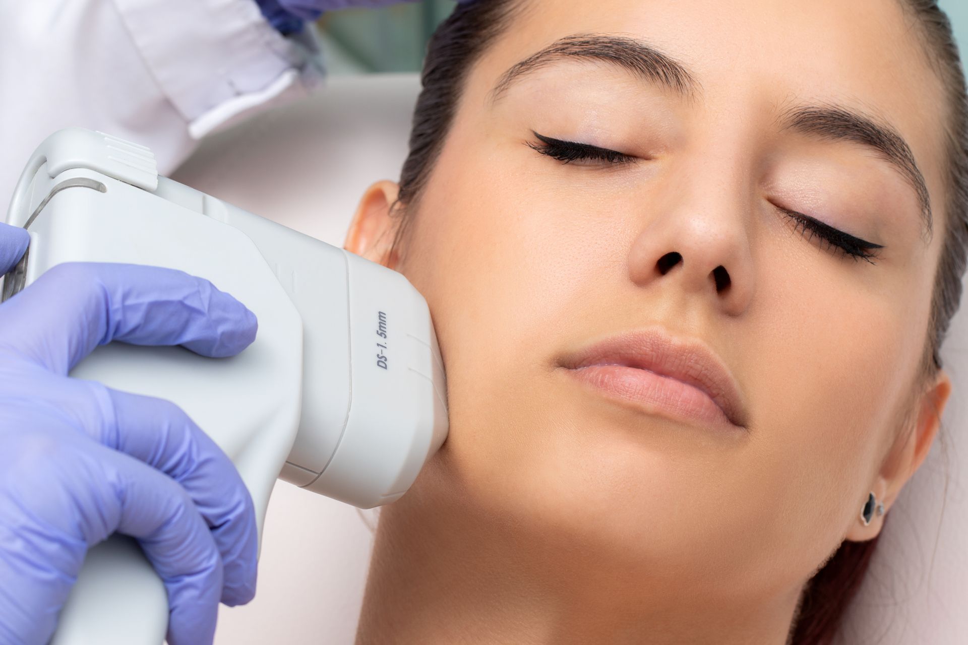 A woman is getting an injection on her stomach in a beauty salon.