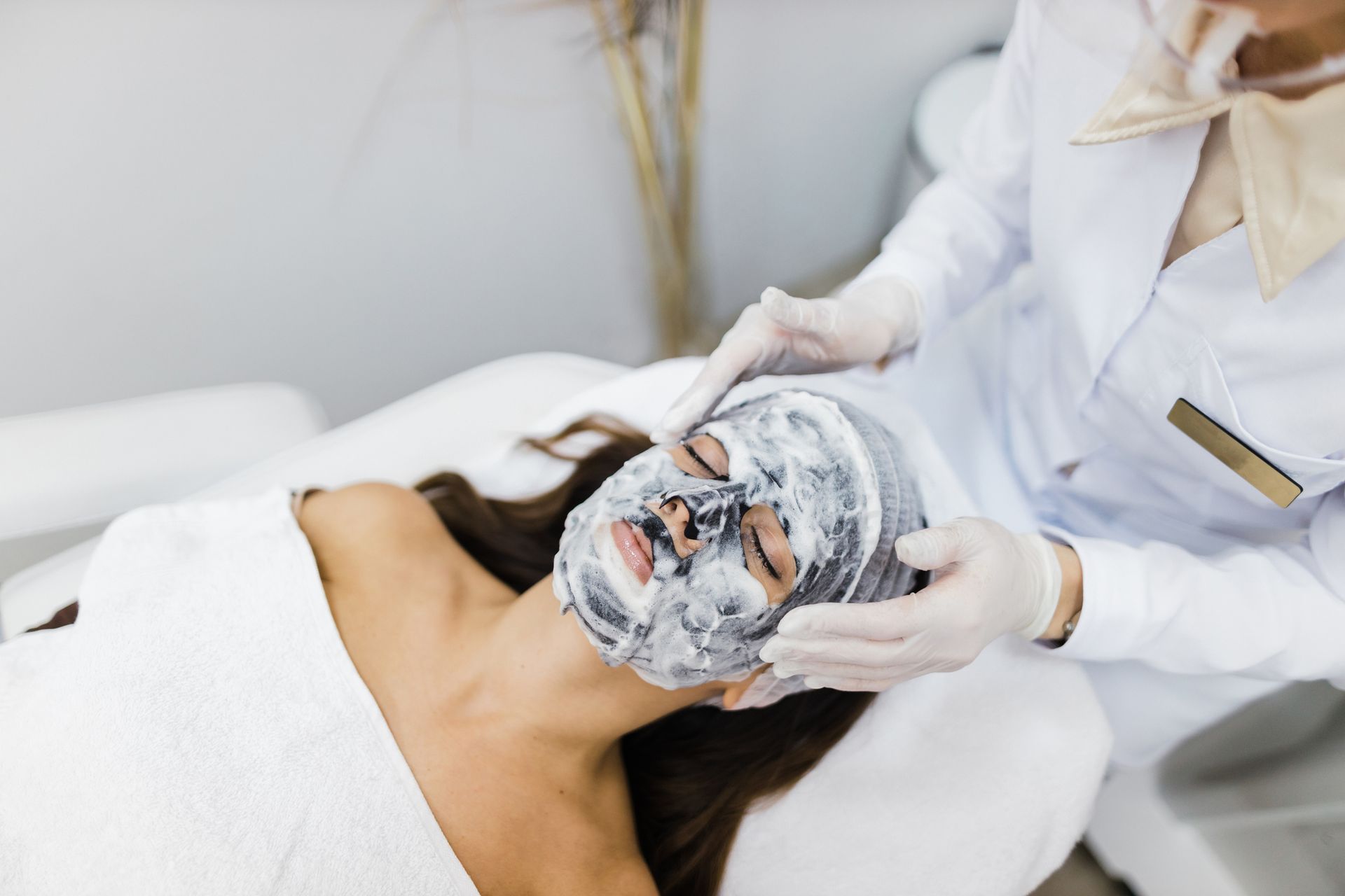 A woman is getting an anti-aging cream.