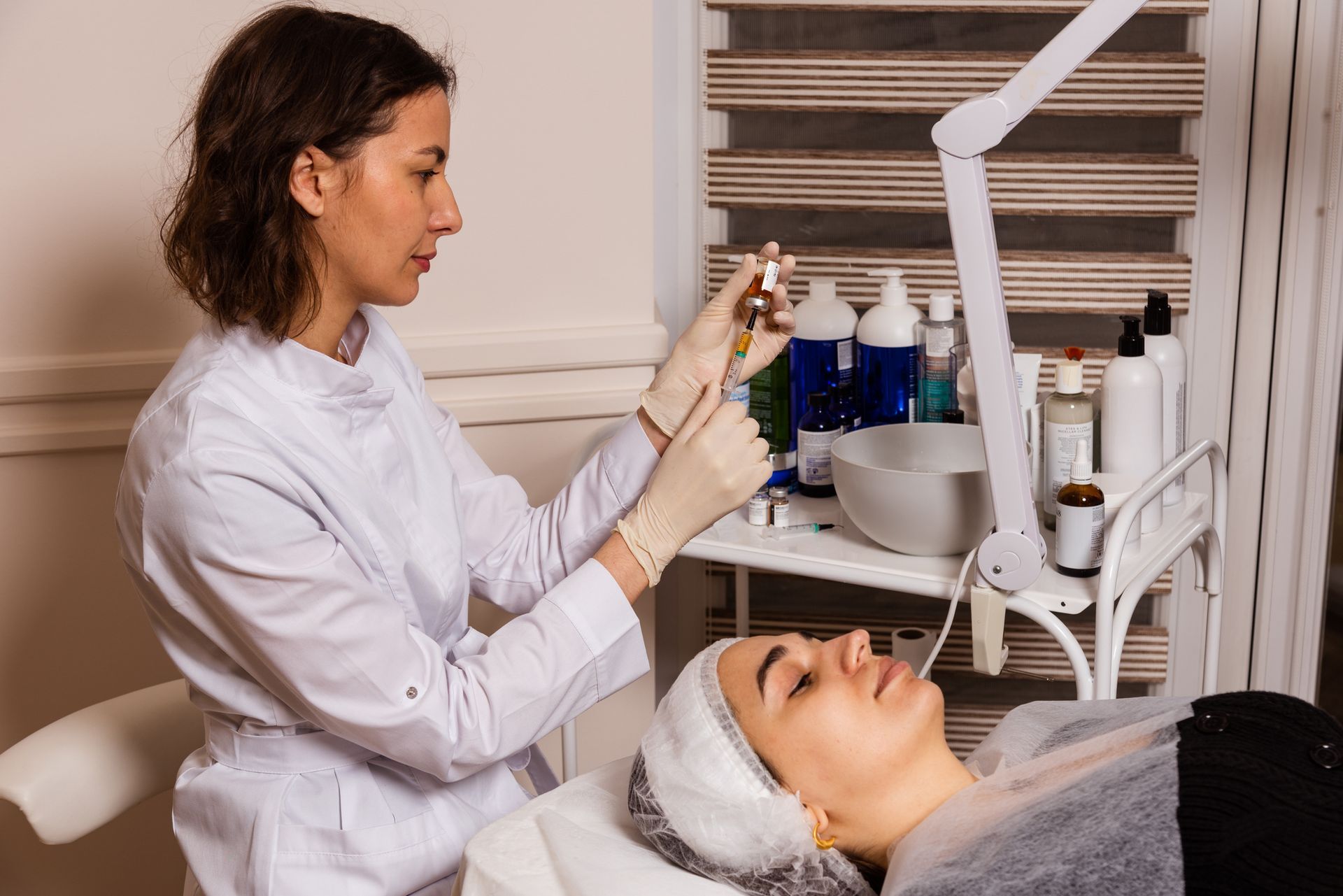 A woman is giving a woman a facial treatment in a beauty salon.