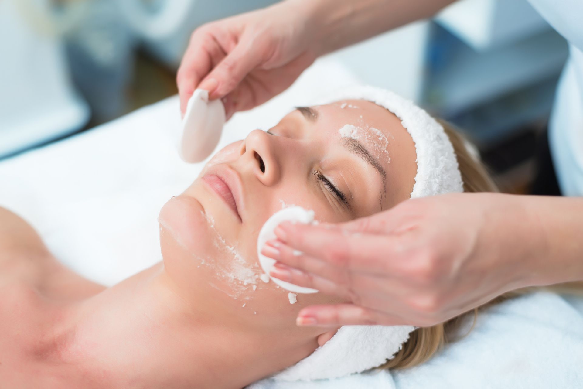 A woman is getting a facial treatment at a spa.