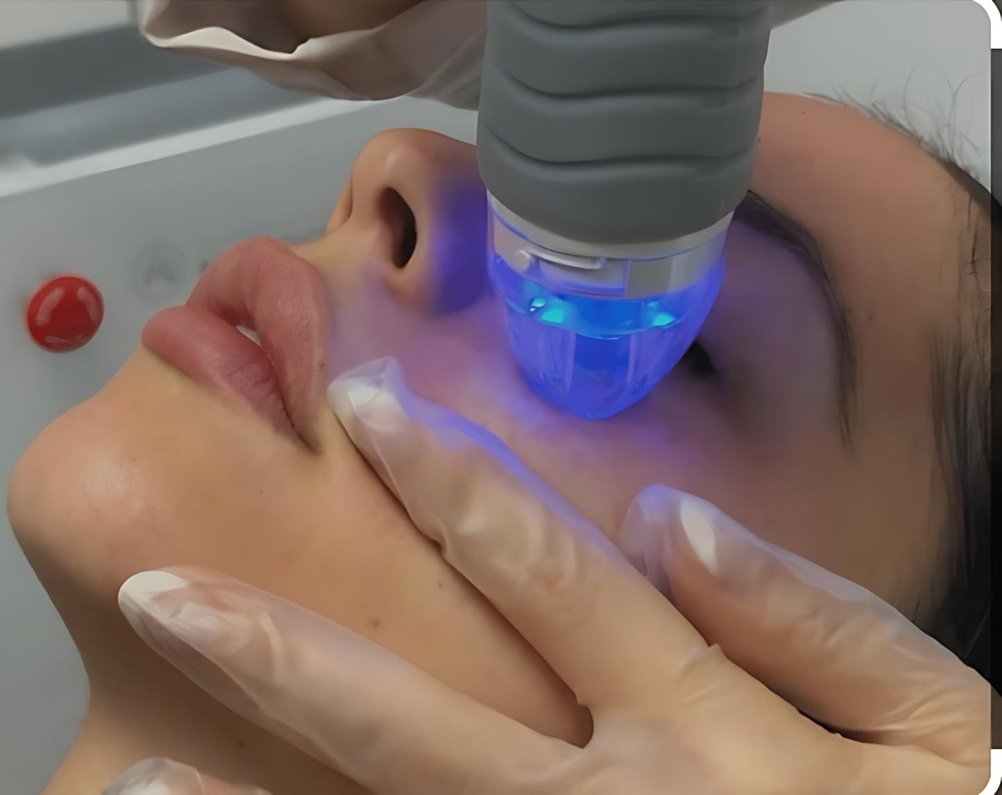 A woman is getting a facial treatment at a beauty salon using a device.