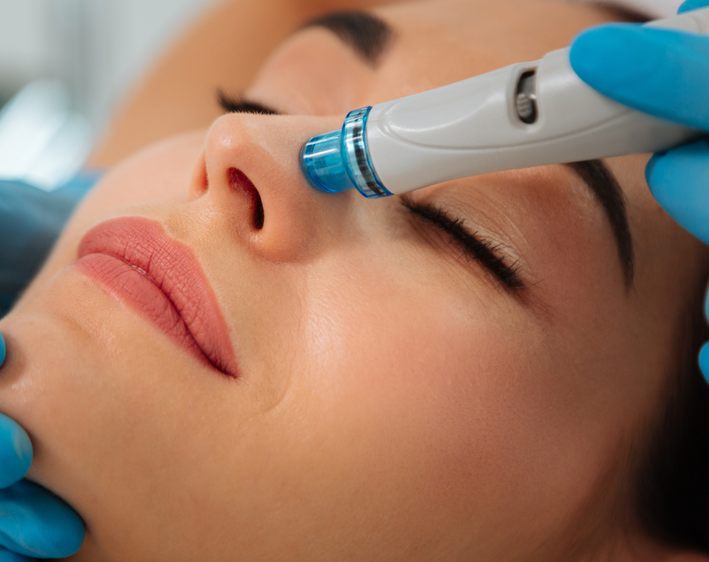 A woman is getting a facial treatment.