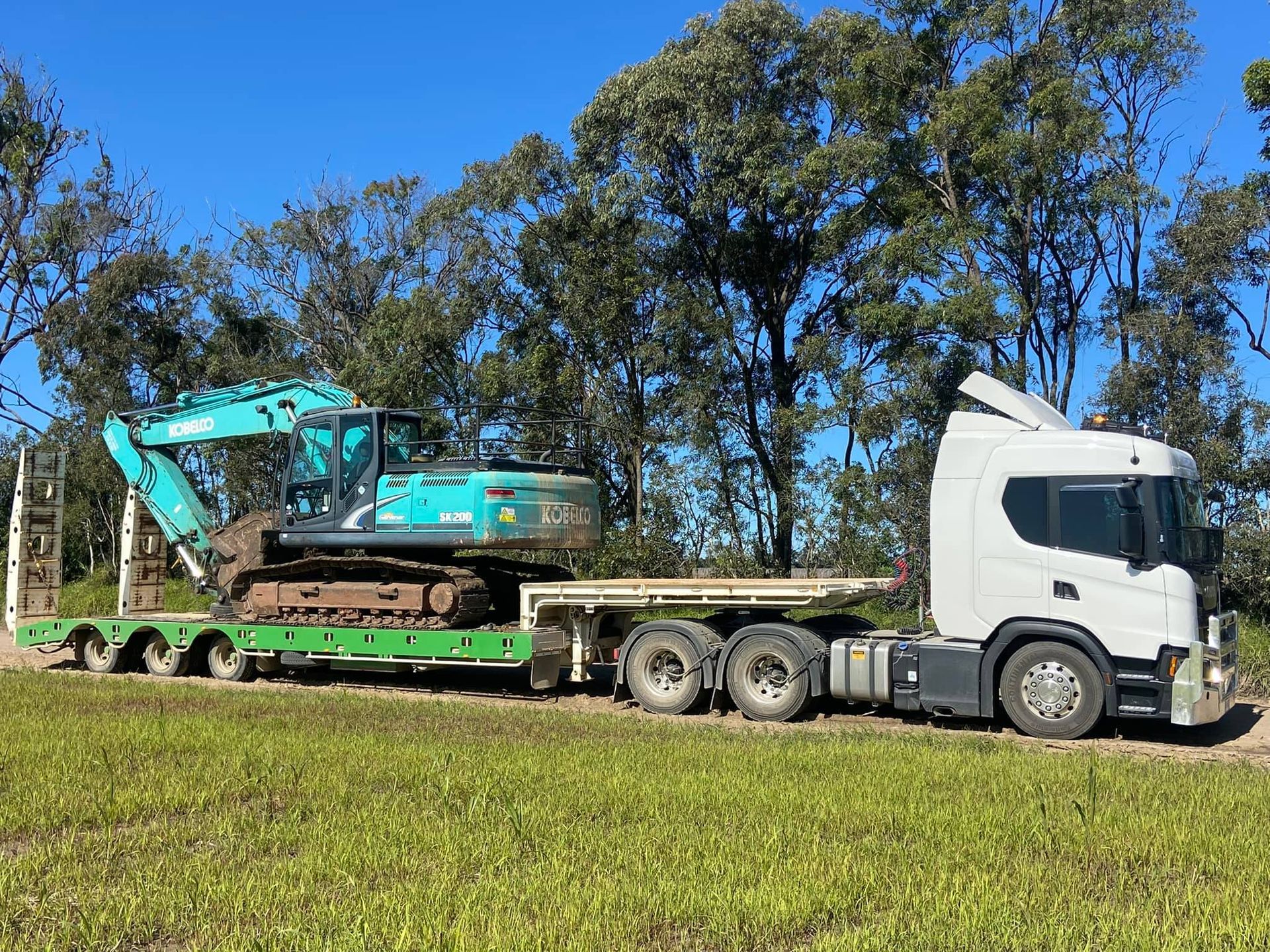 Excavator Pouring Dirt into Container — Soil Conditioning in Alloway, QLD