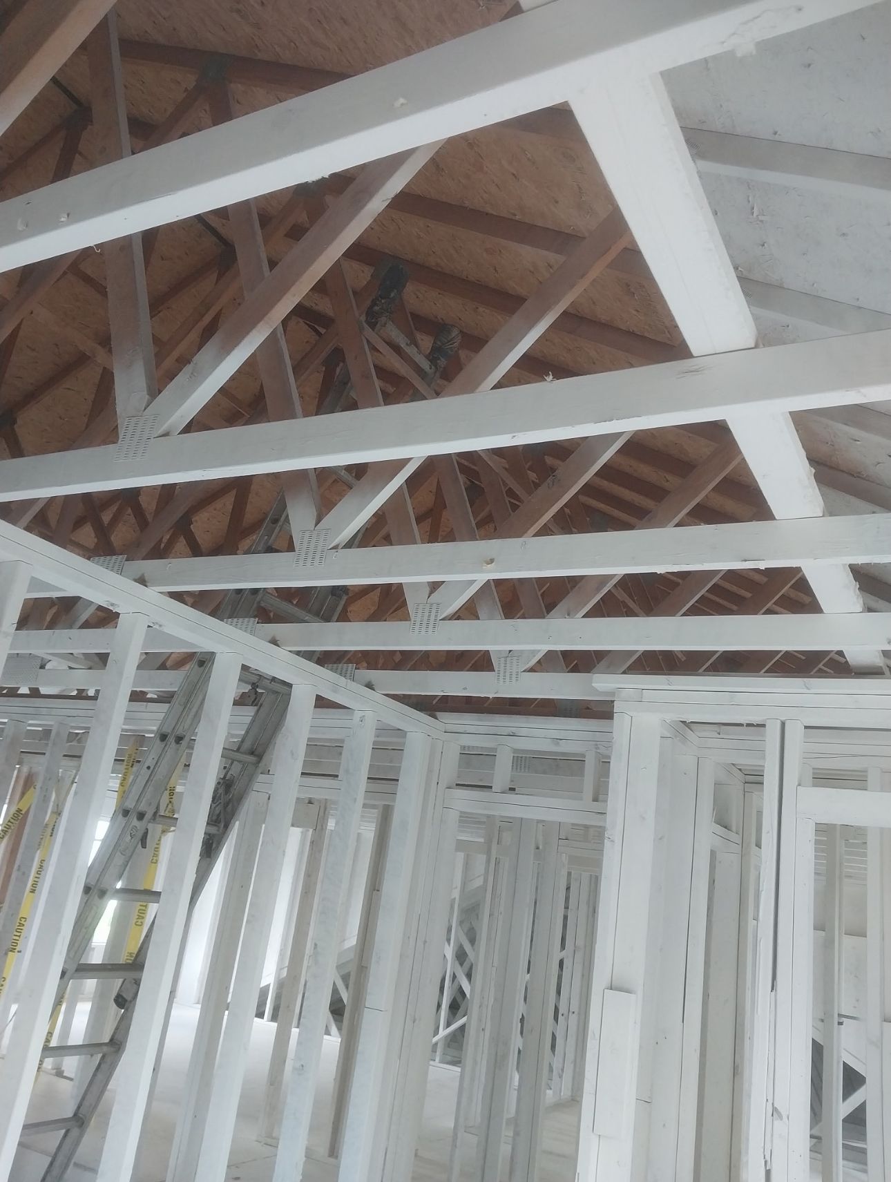 An empty room with a curved staircase and a large window