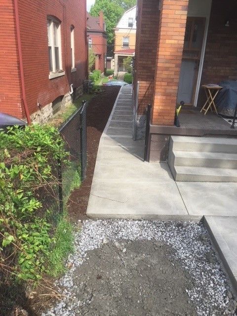 A sidewalk is being built in front of a brick house. - Gibsonia, PA - Langell Concrete Construction