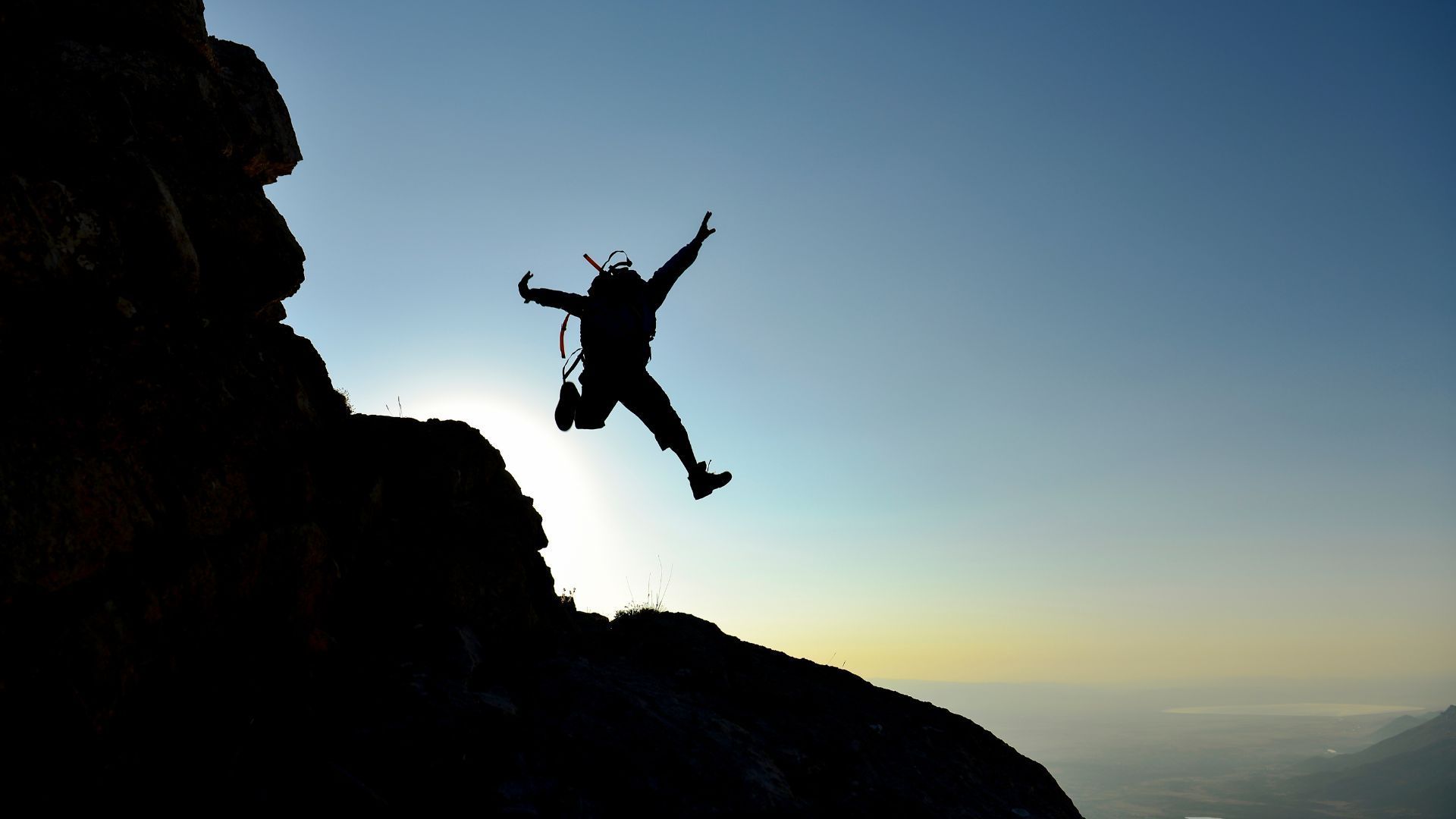 People in an office shaking hands, smiling.