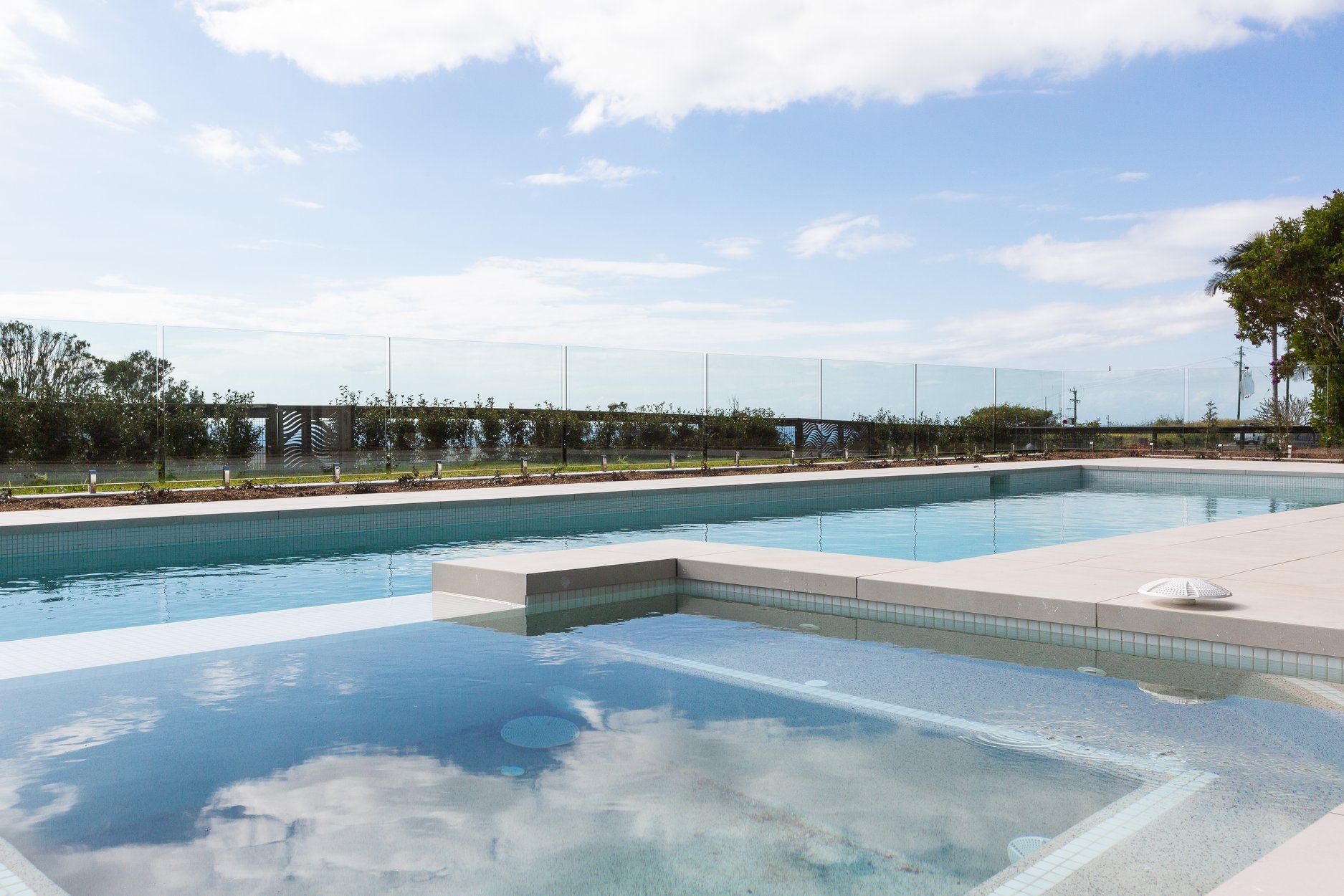 A Large Swimming pool with a hot tub in the Middle of it — Profile Pools & Landscaping In Byron Bay, NSW