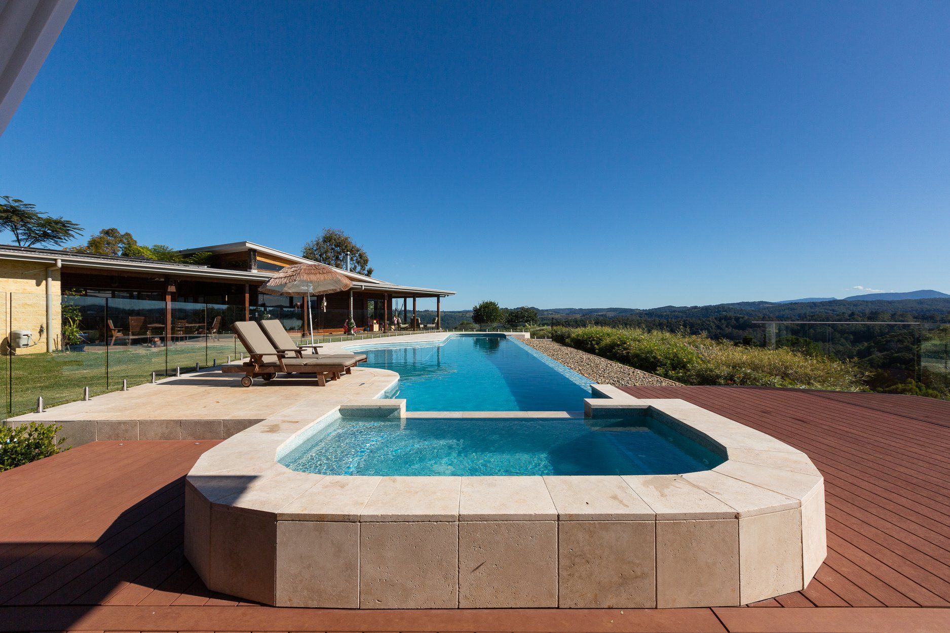 A Large Swimming Pool with a Hot tub in the Middle of it — Profile Pools & Landscaping In Byron Bay, NSW