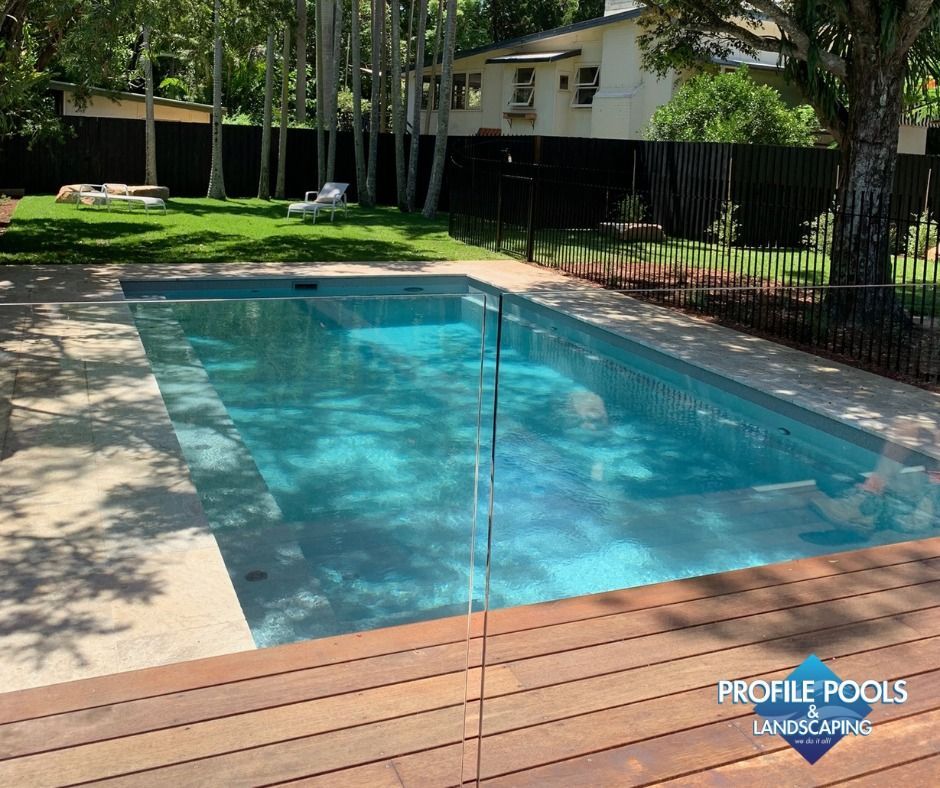 Luxury Swimming Pool View With Blue Water Poolside With Chairs And Small Fountain — Profile Pools & Landscaping In Bangalow, NSW