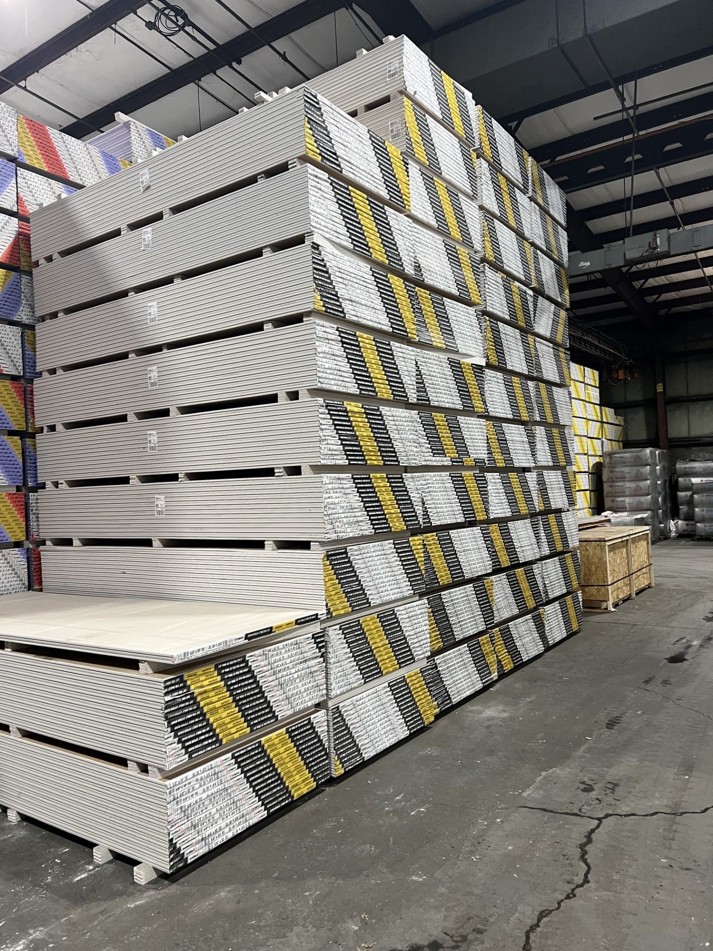 Person with tool bags walking towards a house with a yellow door.