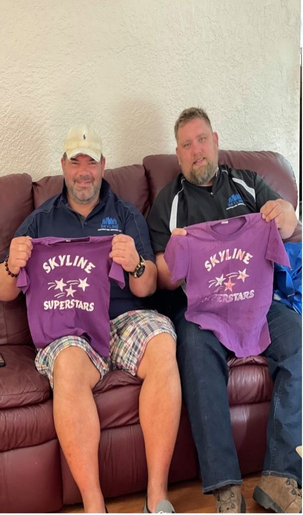 Tools arranged on a wooden surface, including hammers, wrenches, pliers, and a screwdriver.