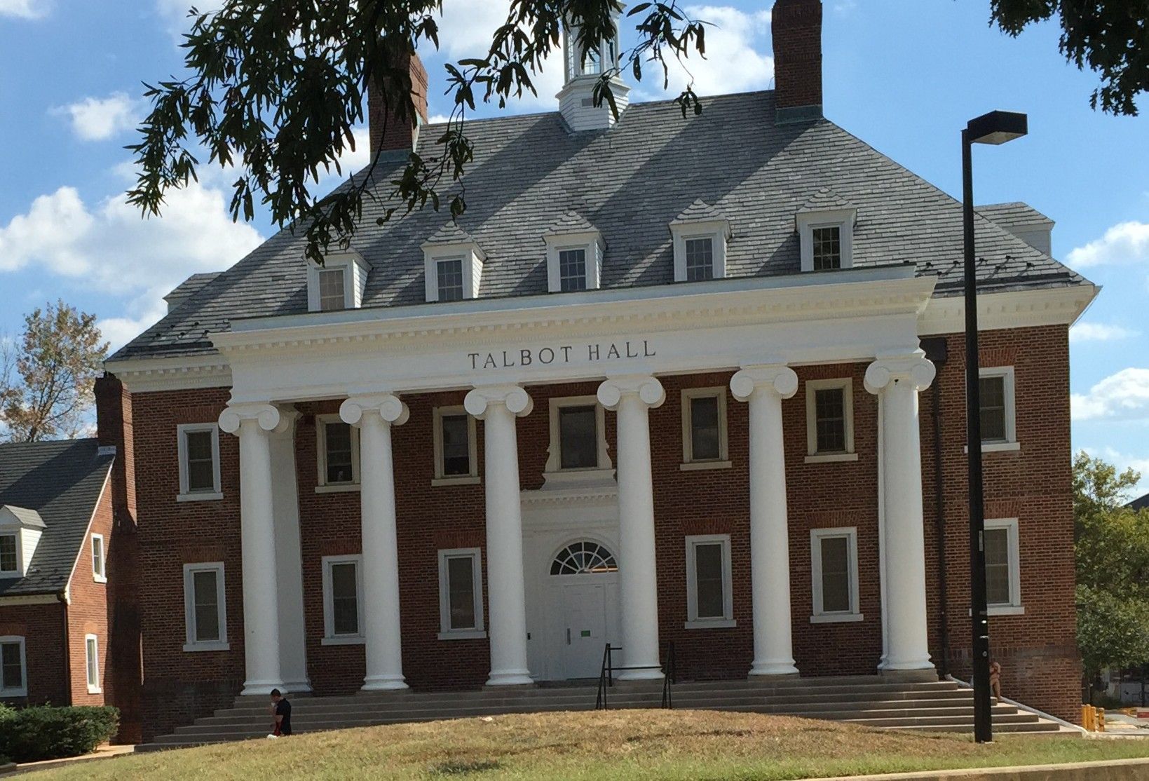 Tools arranged on a wooden surface, including hammers, wrenches, pliers, and a screwdriver.