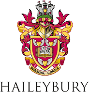 The logo for haileybury is a coat of arms with a castle on it.