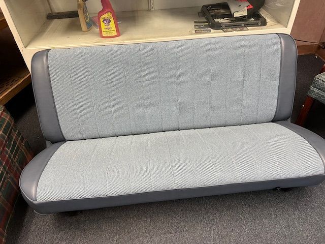 Light blue and gray bench seat with textured fabric and rounded edges.