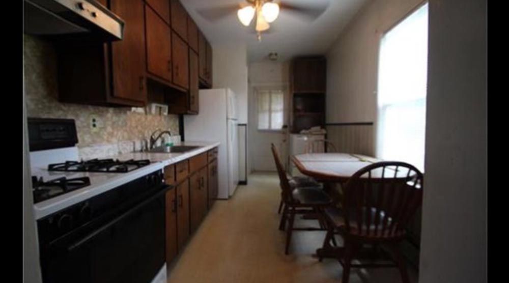 Pre-renovation kitchen with dark wood cabinets and vintage appliances, ready for remodeling