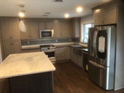 Modern kitchen remodel with marble island, stainless steel appliances, and custom cabinetryn Scotch Plains, NJ.