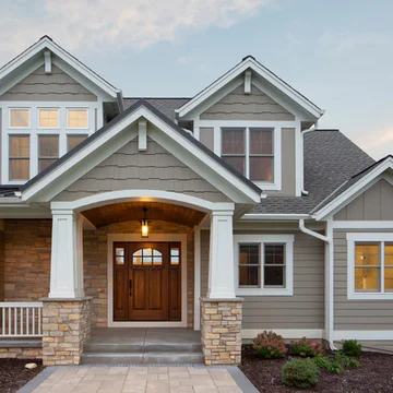 A large house with a porch and a wooden door