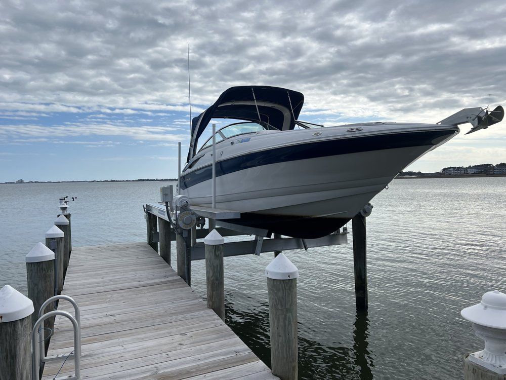 A boat is sitting on top of a dock in the water.