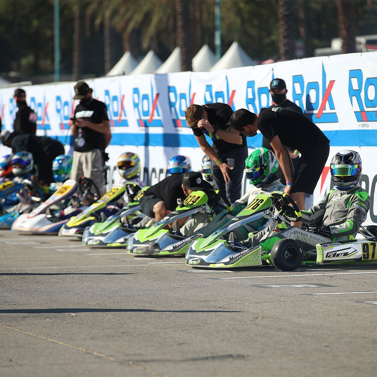 A row of go karts are lined up in front of a sign that says rok