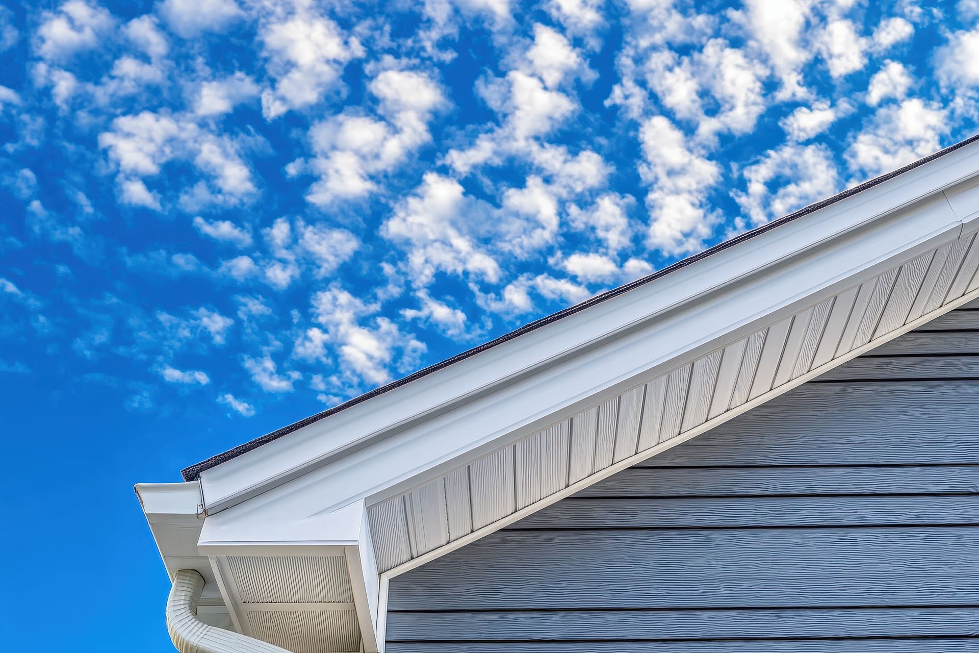 The roof of a house with a blue sky in the background.