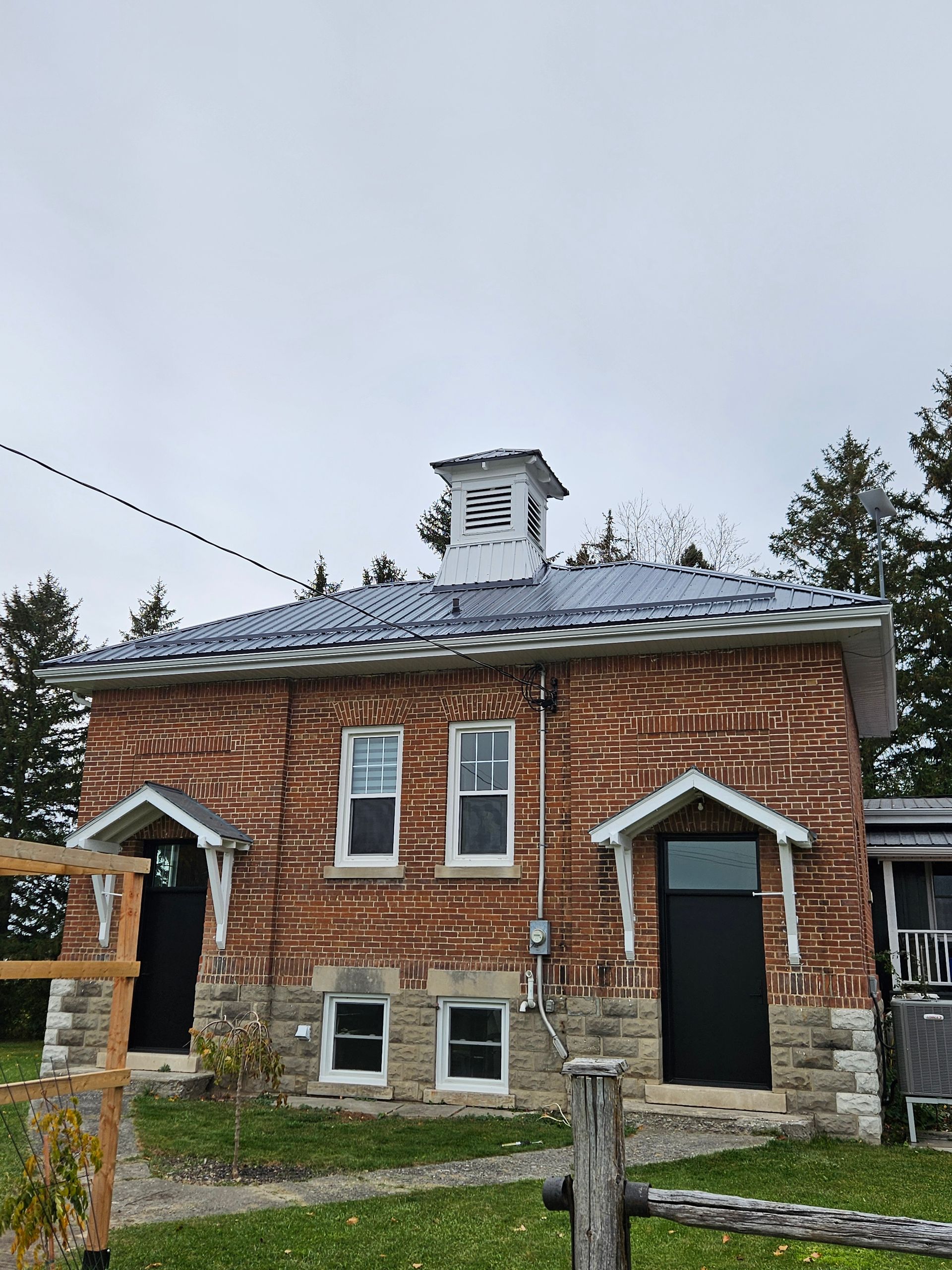 A brick building with a clock tower on top of it
