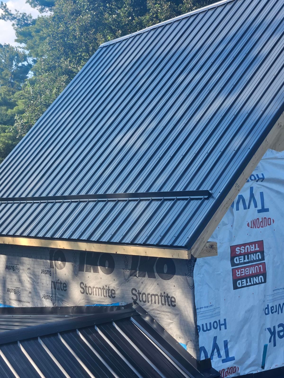 A metal roof is being installed on a house.