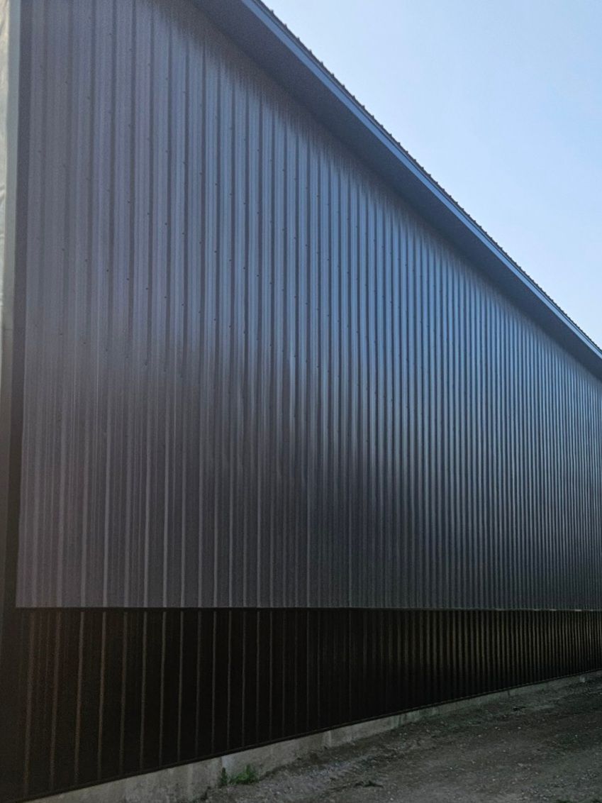 A large black building with a blue sky in the background.