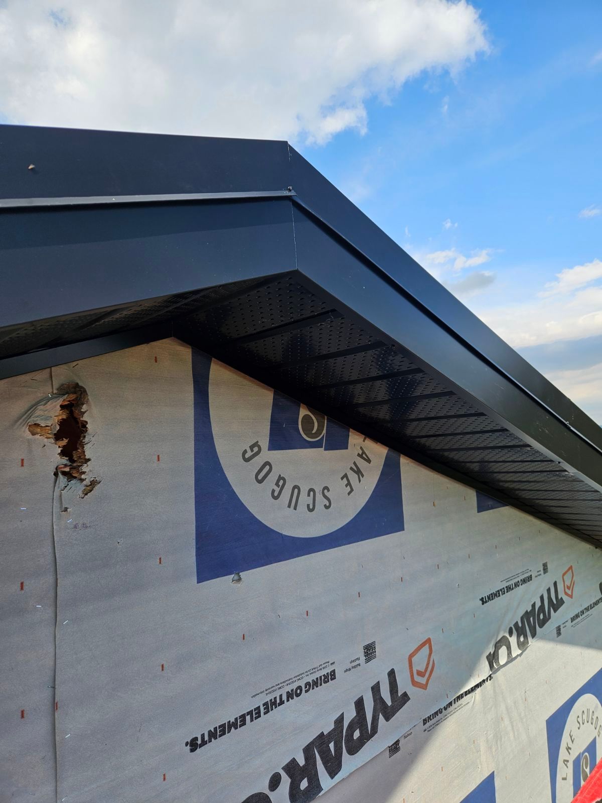 A roof with a tarp on it that says typar