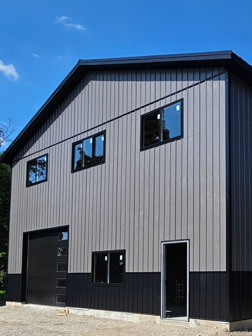 A large building with a lot of windows and a black garage door.