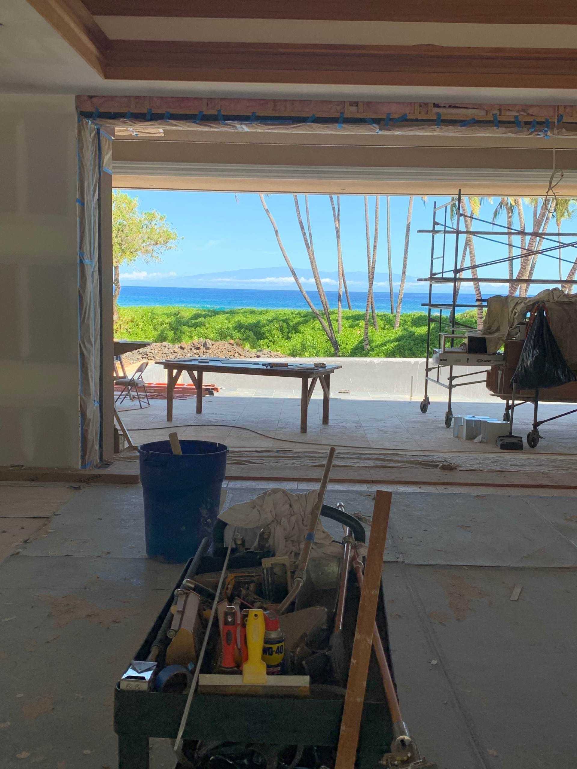 A room under construction with a view of the ocean.