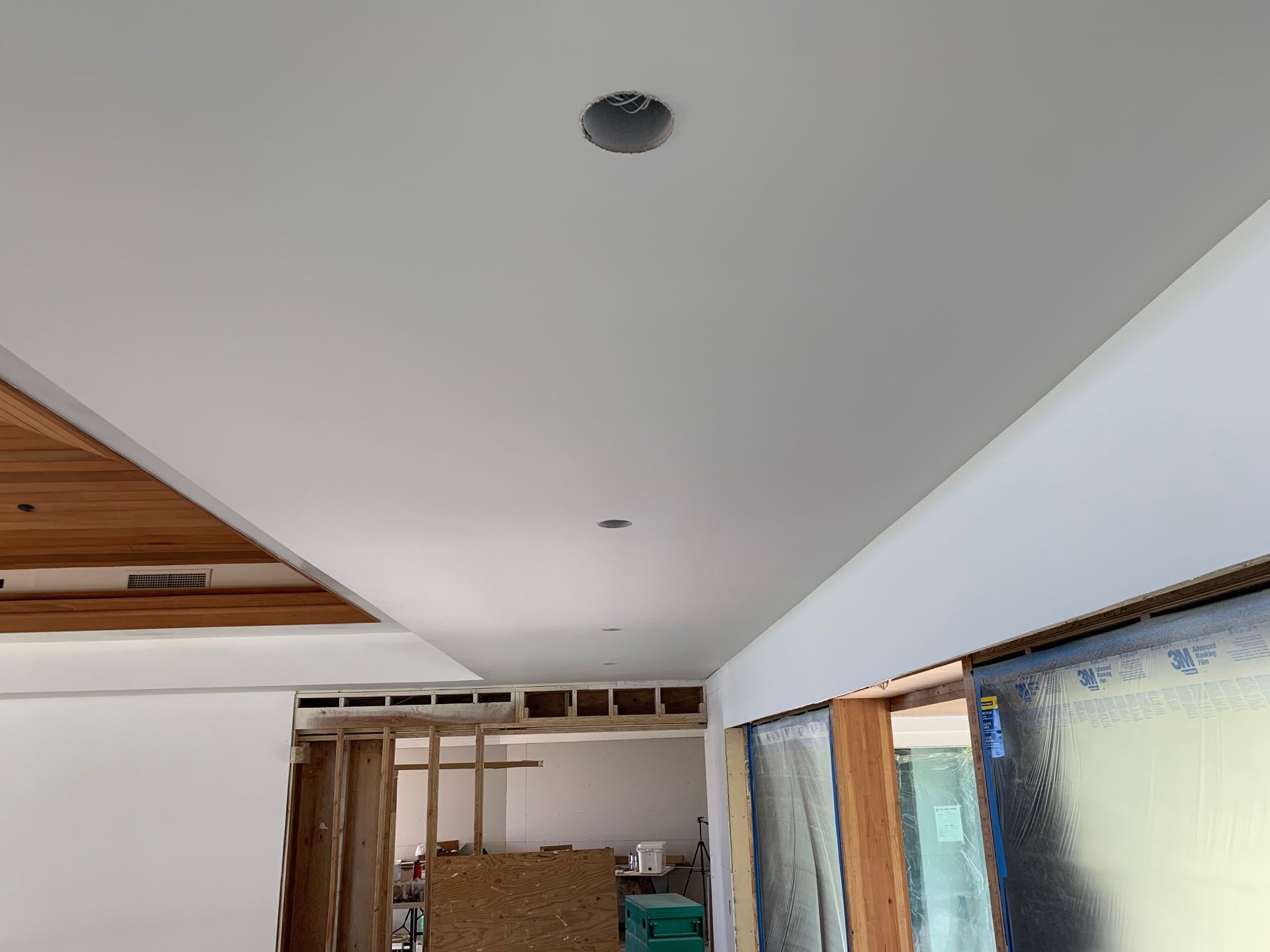 A room with a white ceiling and a wooden ceiling.