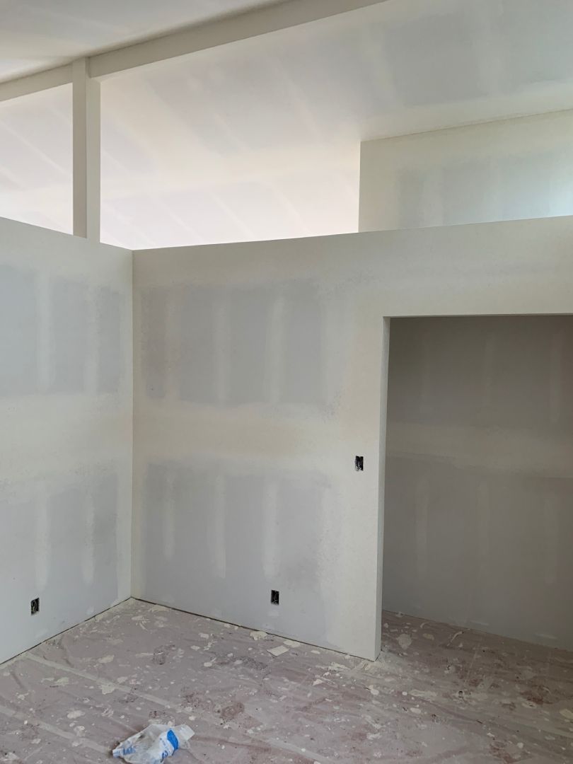 A room with a lot of white walls and a ceiling.