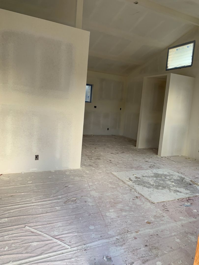 A large empty room with white walls and a white floor.