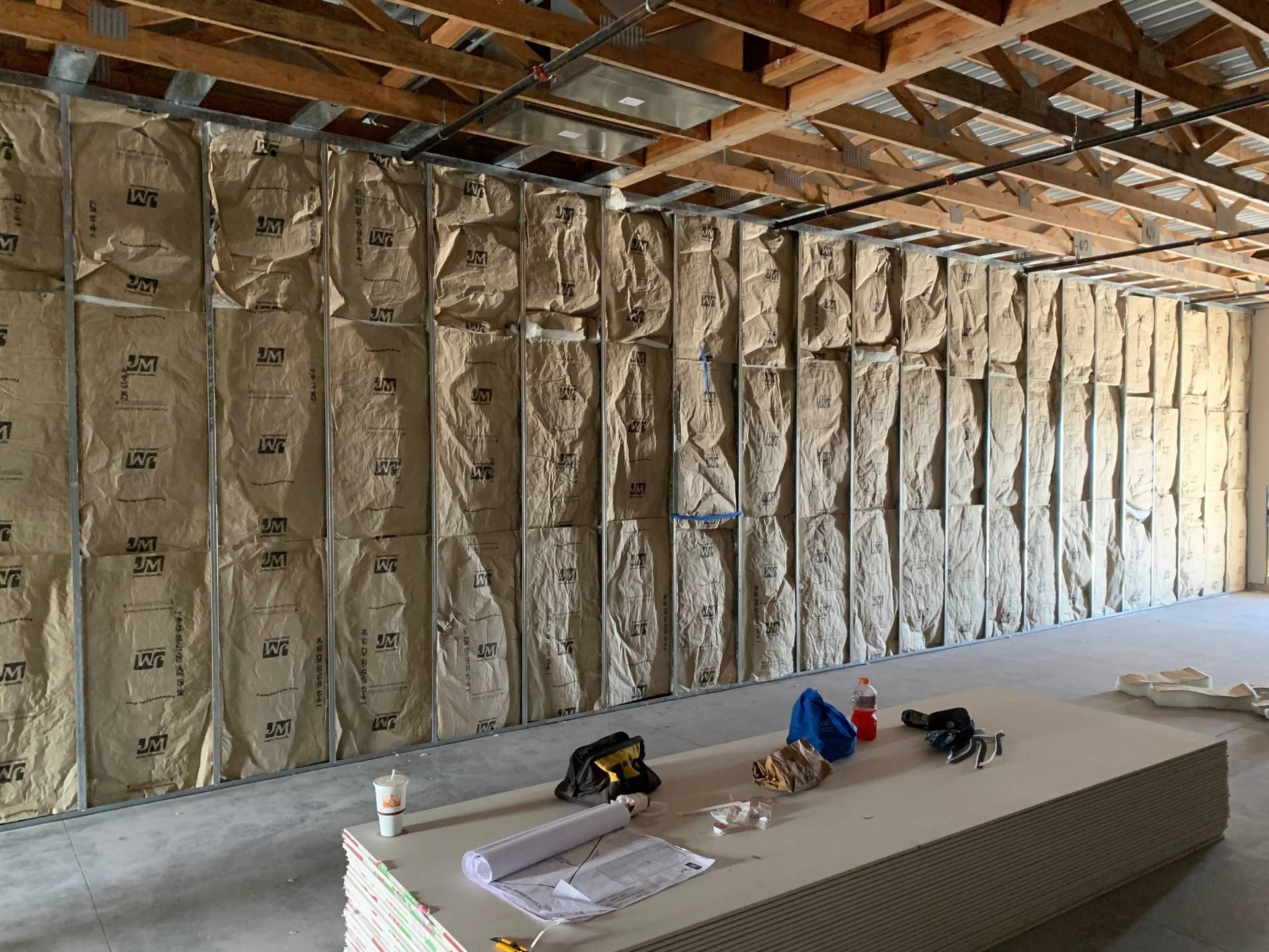 A room with a lot of insulation on the walls and a table with tools on it.