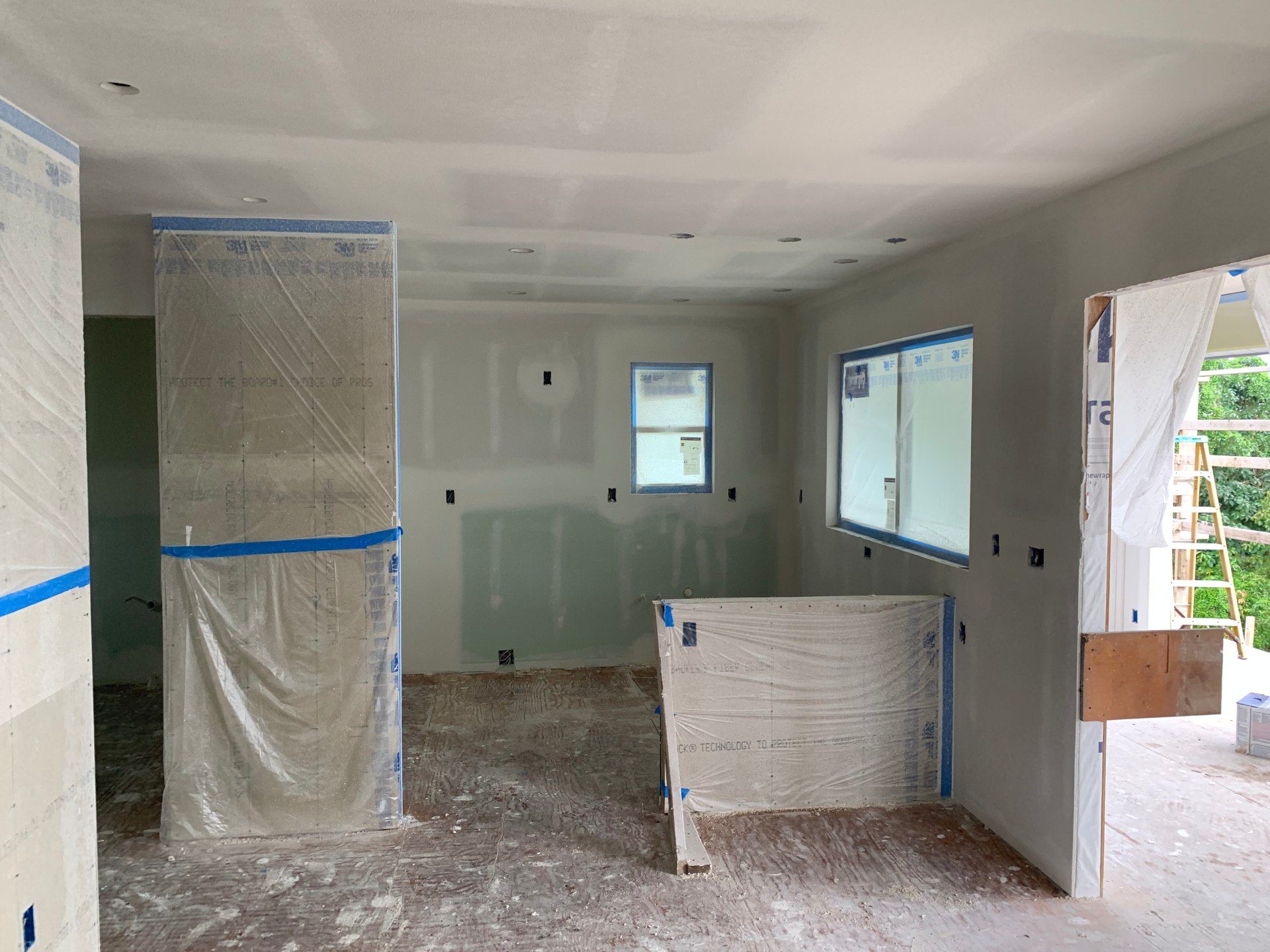 A room in a house that is being remodeled and drywall installed. 
