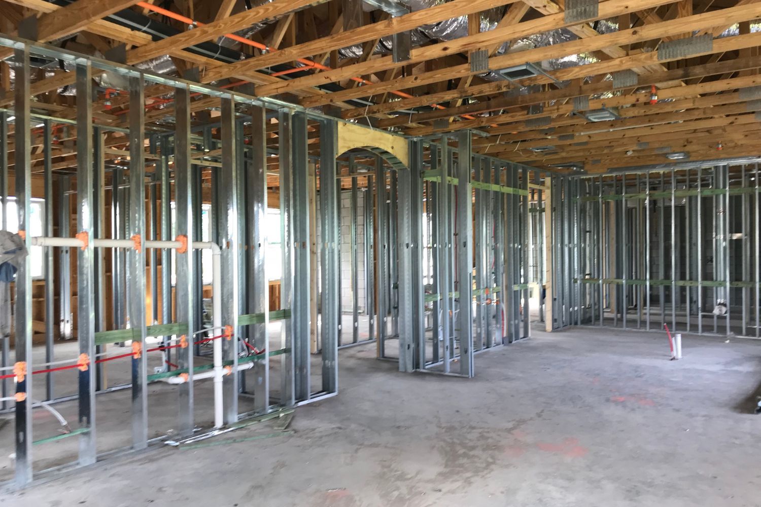 The inside of a building under construction with a lot of metal stud frames.