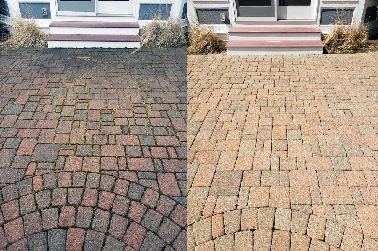 Comparison: Before and after power washing of a brick paver walkway in front of a house, revealing a cleaner surface.