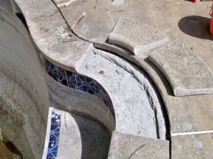 A man is working on a swimming pool pump.