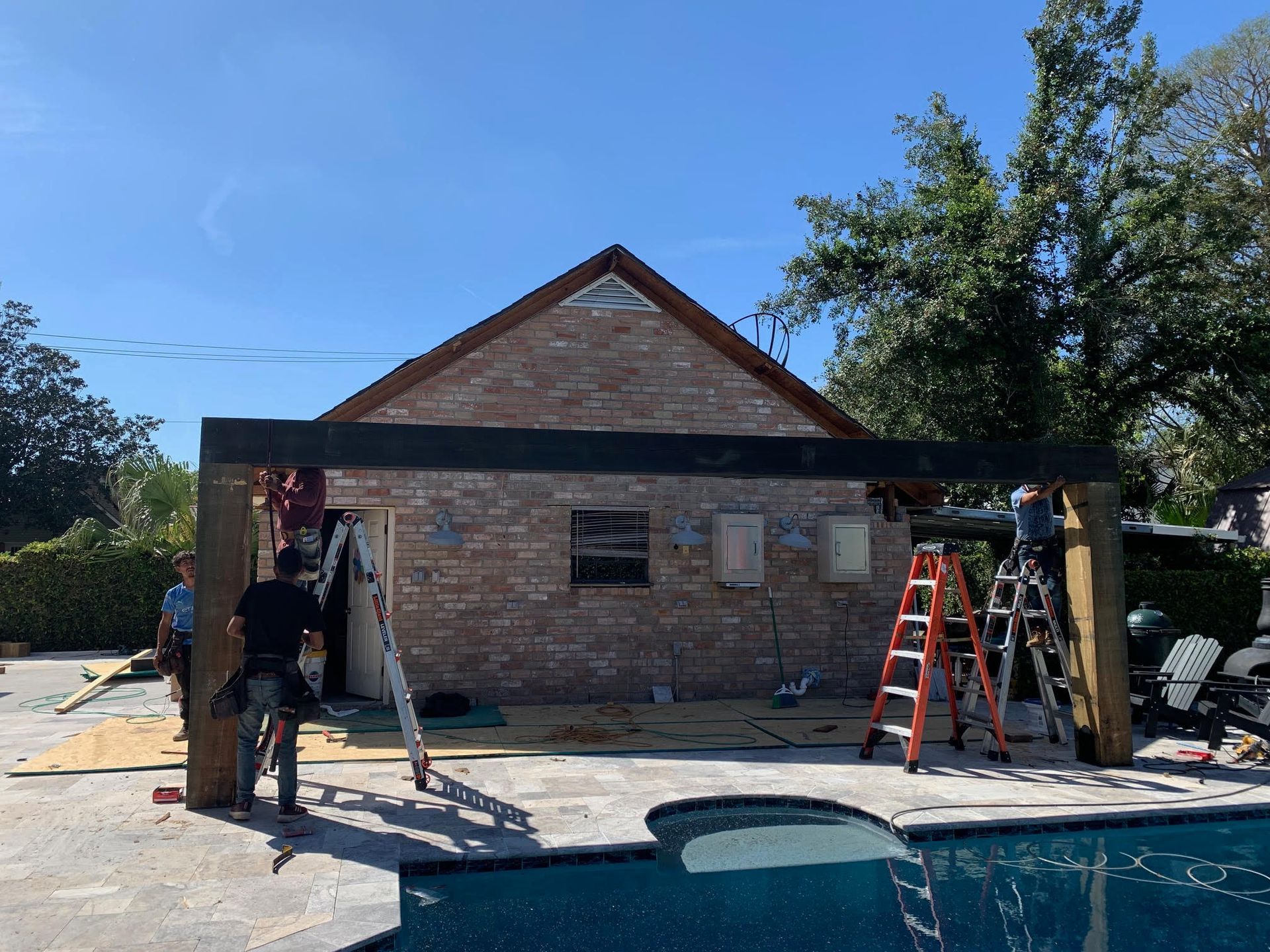 A swimming pool is being remodeled in a backyard.
