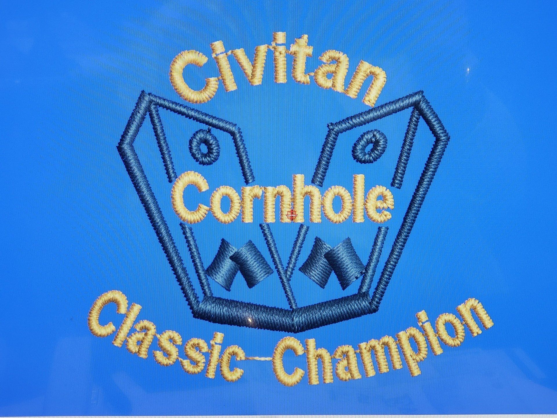 A blue background with the words civitan cornhole classic champion embroidered on it