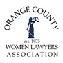 The orange county women lawyers association logo is a statue of a woman holding a scale.