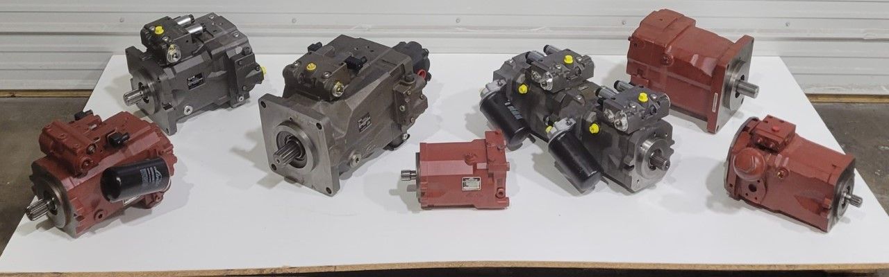 a group of hydraulic pumps are lined up on a table