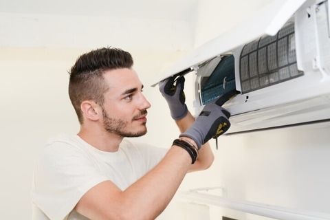 Technician Installing A Unit — Affordable Heating & Air Conditioning Services in Covina, CA